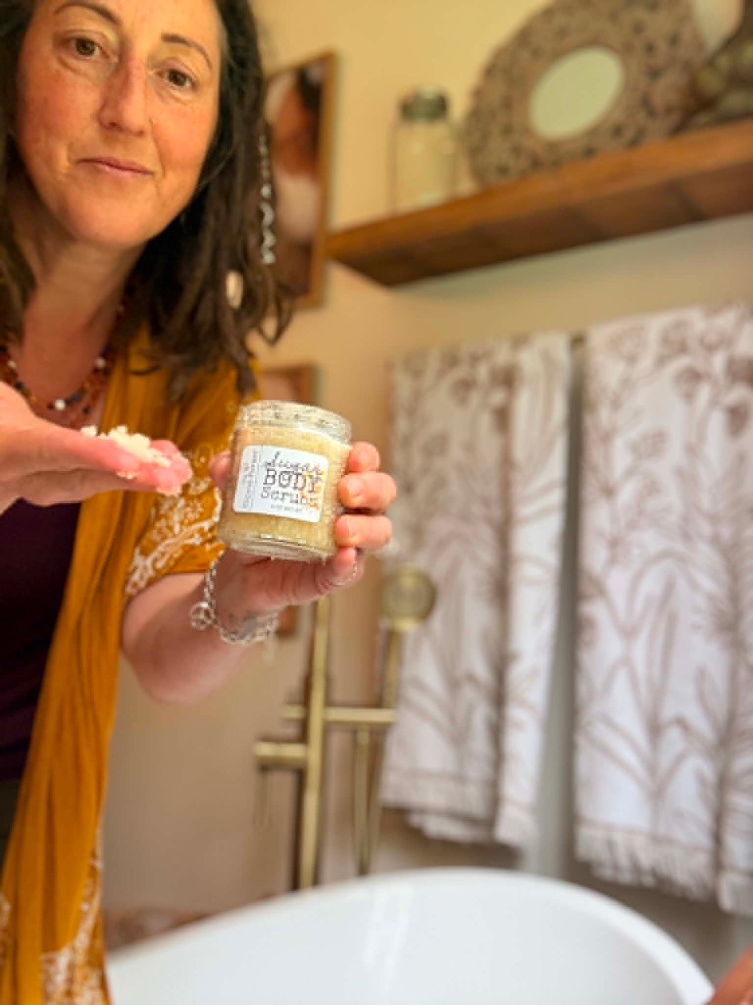 The Hippie Farmer Jenni holding a handmade sugar body scrub